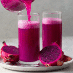 Purple Peel Recipe: The Shocking Fat-Burning Drink boosted My Energy 7 Dragon fruit smoothie being poured into a glass with fresh fruit on the side
