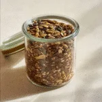 Homemade bariatric seed trick mix in a clear glass jar on kitchen counter