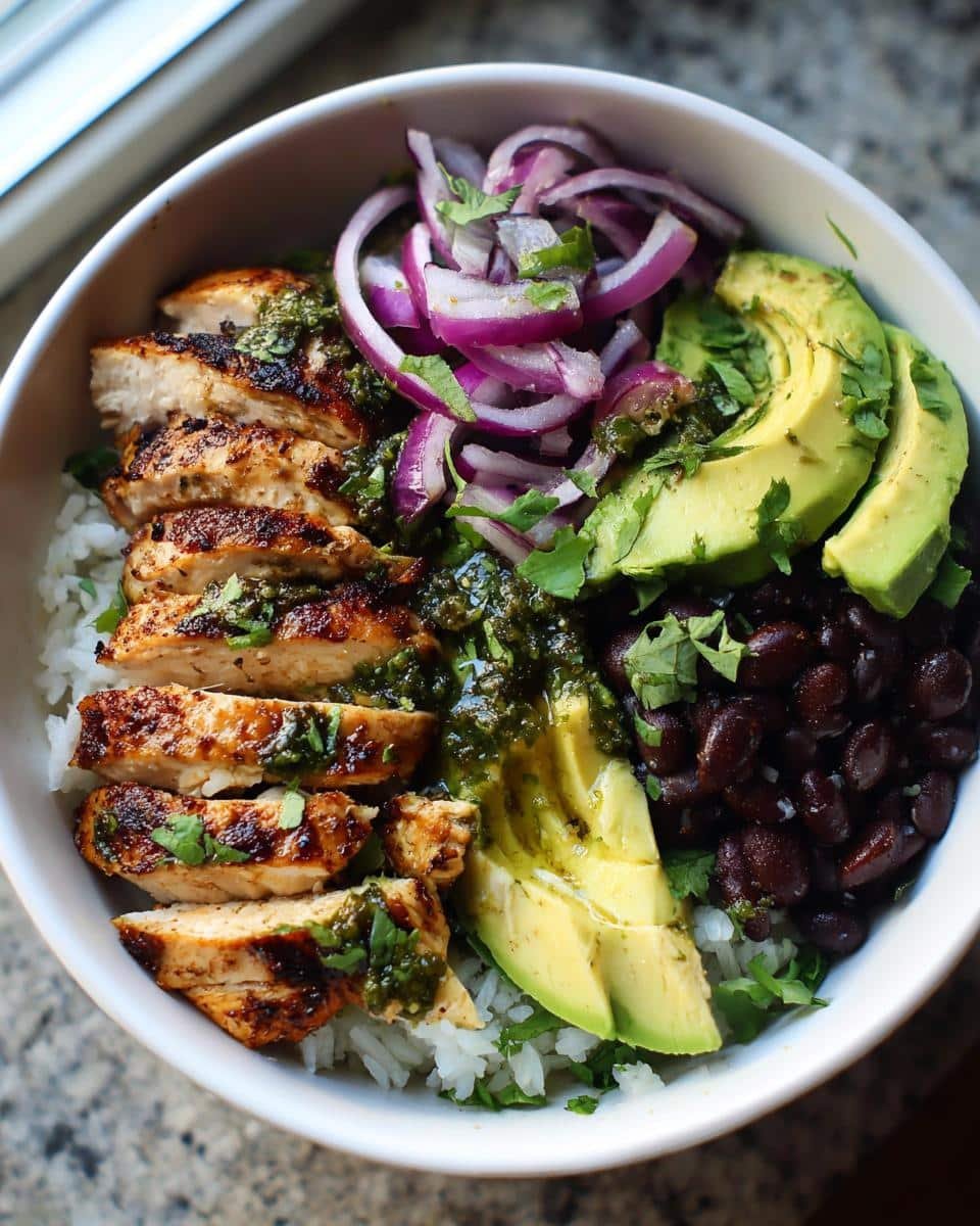 Chimichurri Chicken Bowl: Ditch Sad Bowls in 40 Minutes 8 A vibrant Chimichurri Grilled Chicken Bowl with rice, avocado, black beans, and red onion.