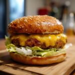 A mouthwatering Crack Burger featuring a juicy patty, melted cheese, and fresh lettuce on a sesame seed bun.