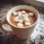 Mug of Creamy Crockpot Hot Chocolate topped with marshmallows, ready to enjoy.