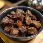A bowl filled with juicy Crockpot Steak Bites, cooked to perfection and ready to serve.