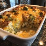A delicious Easy Low Carb Chicken Casserole with broccoli and melted cheese in a white baking dish.