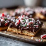 Close-up of Easy Peppermint Bark Graham Crackers with chocolate and crushed peppermint candies.
