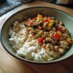 A delicious Ground Turkey Cottage Cheese Bowl with colorful vegetables in a green bowl.