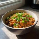 A bowl of Healthy Egg Roll in a Bowl Recipe, topped with fresh green onions.
