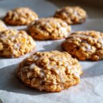 Close-up of Lemon Oatmeal No-Bake Cookies with a sweet glaze on parchment paper.