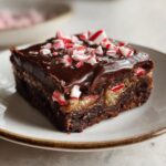 Close-up of an Easy One Bowl Peppermint Brownie with Chocolate Ganache, topped with crushed peppermint candies.