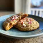 Two Peppermint Sugar Cookies on a blue plate, one broken in half to show the inside.
