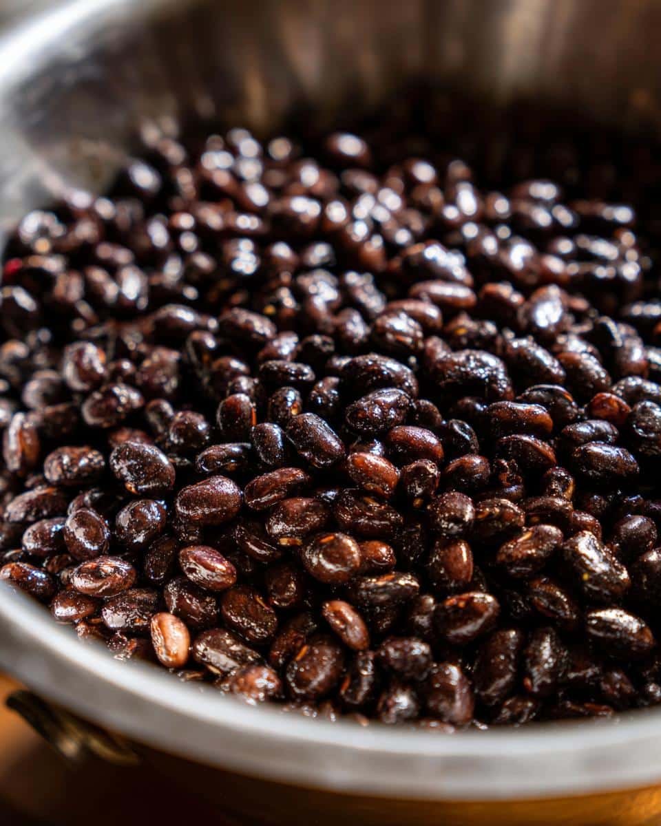 Quick and Easy Seasoned Vegan Black Beans Recipe: A Sin 6 Close-up of seasoned vegan black beans in a metal bowl, ready to be served in a quick and easy recipe.