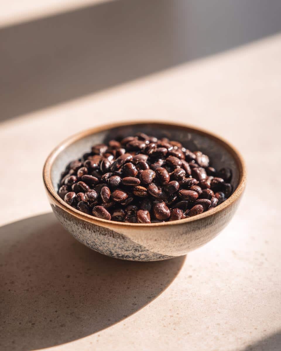 Quick and Easy Seasoned Vegan Black Beans Recipe: A Sin 8 A bowl filled with Quick and Easy Seasoned Vegan Black Beans, ready to be used in a recipe.