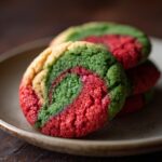 A stack of colorful Swirled Christmas Cookies, featuring red, green, and yellow swirls on a plate.