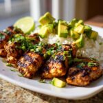 Plate of Zesty Cilantro Lime Chicken with Avocado and Jasmine Rice, garnished with cilantro and a lime wedge.