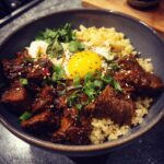 A flavorful Bulgogi Bowls with Quinoa, featuring marinated beef, quinoa, and a fried egg.