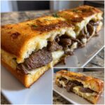 Close-up of a Cheesesteak Stuffed Garlic Loaf, oozing with cheese and tender steak.