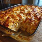 Delicious Chicken Alfredo Pasta Bake in a glass baking dish, golden brown and bubbly.