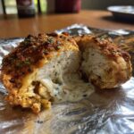 Inside view of crispy chicken bites with 4-ingredient sauce oozing out, garnished with herbs.