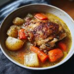 Close-up of a bowl of chicken stew with carrots and potatoes. Not a Creamy Mushroom Risotto Recipe with Parmesan and White Wine.