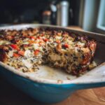 Close-up of Chicken Wild Rice Casserole in a blue baking dish, showing the creamy texture and ingredients.
