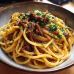 Close-up of a bowl of Creamy Beef Pasta, garnished with fresh parsley. Ready to eat and enjoy!