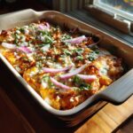 Baked Creamy Mexican Street Corn in a Cup Recipe casserole with cheese, red onions, and cilantro.