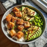 Delicious Crispy Salmon Bowl with avocado, edamame, rice, and sesame seeds. Ready in 30 minutes!