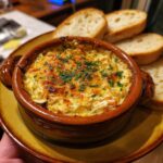 Delicious Easy Cold Crab Dip Recipe served in a bowl with toasted bread slices for dipping.