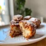 Close-up of Fluffy Cinnamon Roll French Toast Bites Recipe, split open and dusted with powdered sugar.