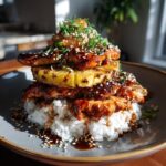 A flavorful Hawaiian Huli Huli Chicken Stack with grilled pineapple, rice, and sesame seed garnish.
