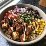 A colorful High Protein BBQ Ranch Chicken Bowl with chicken, quinoa, corn, black beans, and vegetables.