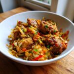 A bowl of flavorful Jamaican Chicken and Cabbage, featuring tender chicken and colorful vegetables.