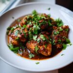 A flavorful plate of Mexican Chicken Adobo, garnished with fresh cilantro. Ready to eat!