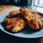 Close-up of Parmesan Crusted Chicken cooked in an air fryer, golden brown and crispy.