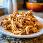 Close-up of tender pulled chicken, perfect for Easy Vintage Cranberry Noel Dessert Recipe.