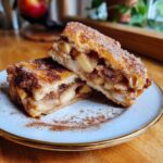 Two Chicago-Style Bakery Apple Slices stacked on a plate, showcasing the apple filling and cinnamon sugar topping.