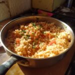 A pan filled with easy Mexican rice with Rotel, garnished with fresh parsley.