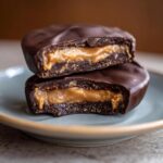 Two halves of a Giant Reese’s Peanut Butter Cup stacked to show the peanut butter filling.