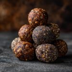 A stack of delicious homemade protein balls on a dark surface. Perfect for a quick snack.