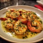 Close-up of a plate of shrimp scampi, showcasing the shrimp, garlic, parsley, and buttery sauce. Shrimp recipes.