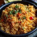 Close-up of a bowl of rice with chopped tomatoes and parsley.