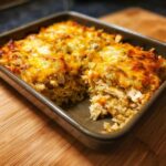 Baked mexican chicken rice and cheese casserole in a baking dish, ready to serve.