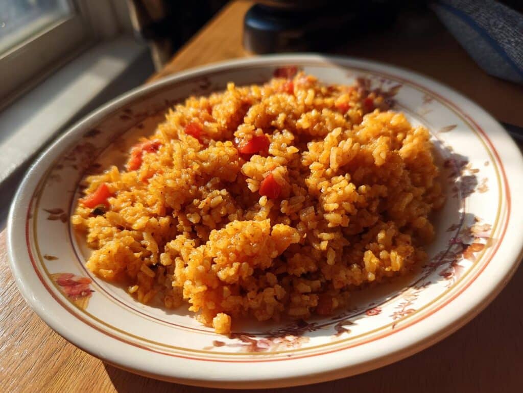 A plate of vibrant rice cooker Mexican rice with Rotel, showcasing the dish's texture and color.